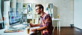 man sitting before a laptop in an office